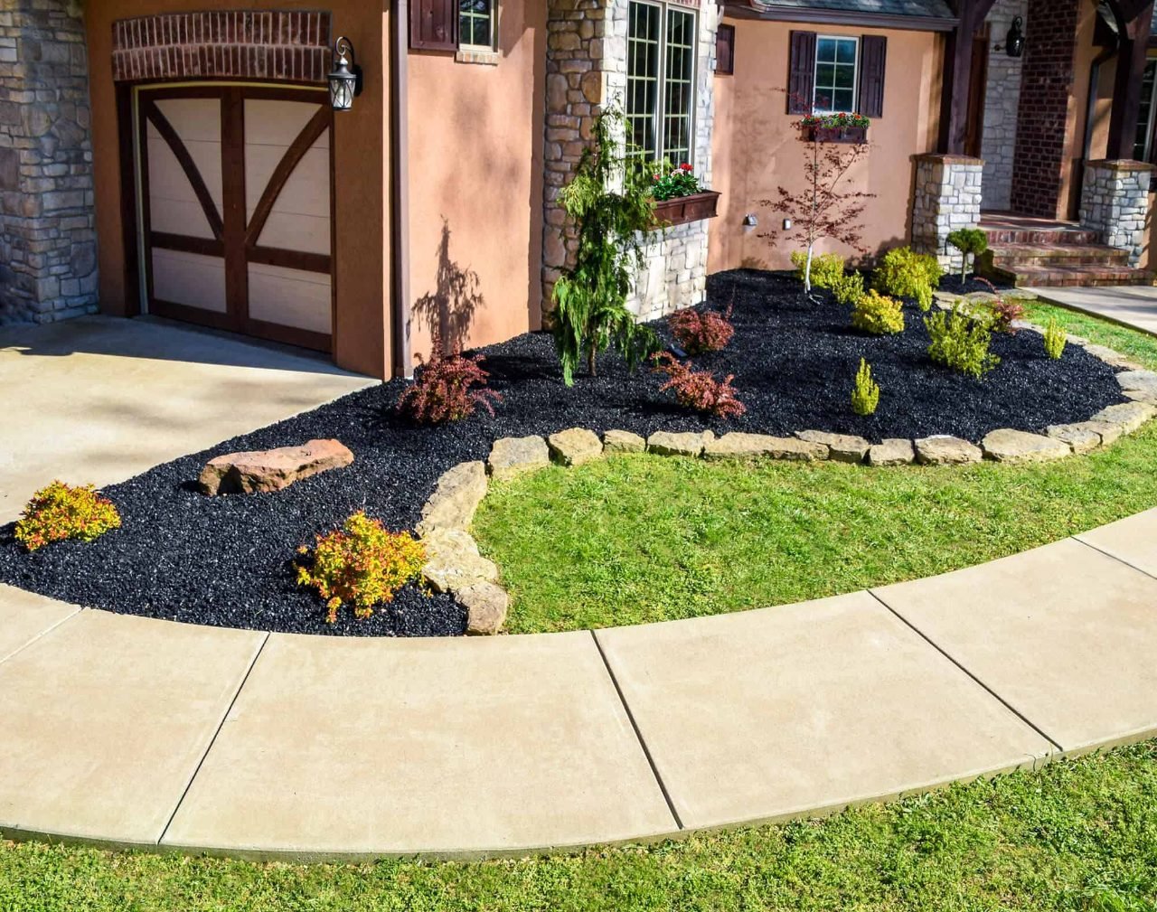 Black rubber mulch installed in a residential landscape bed