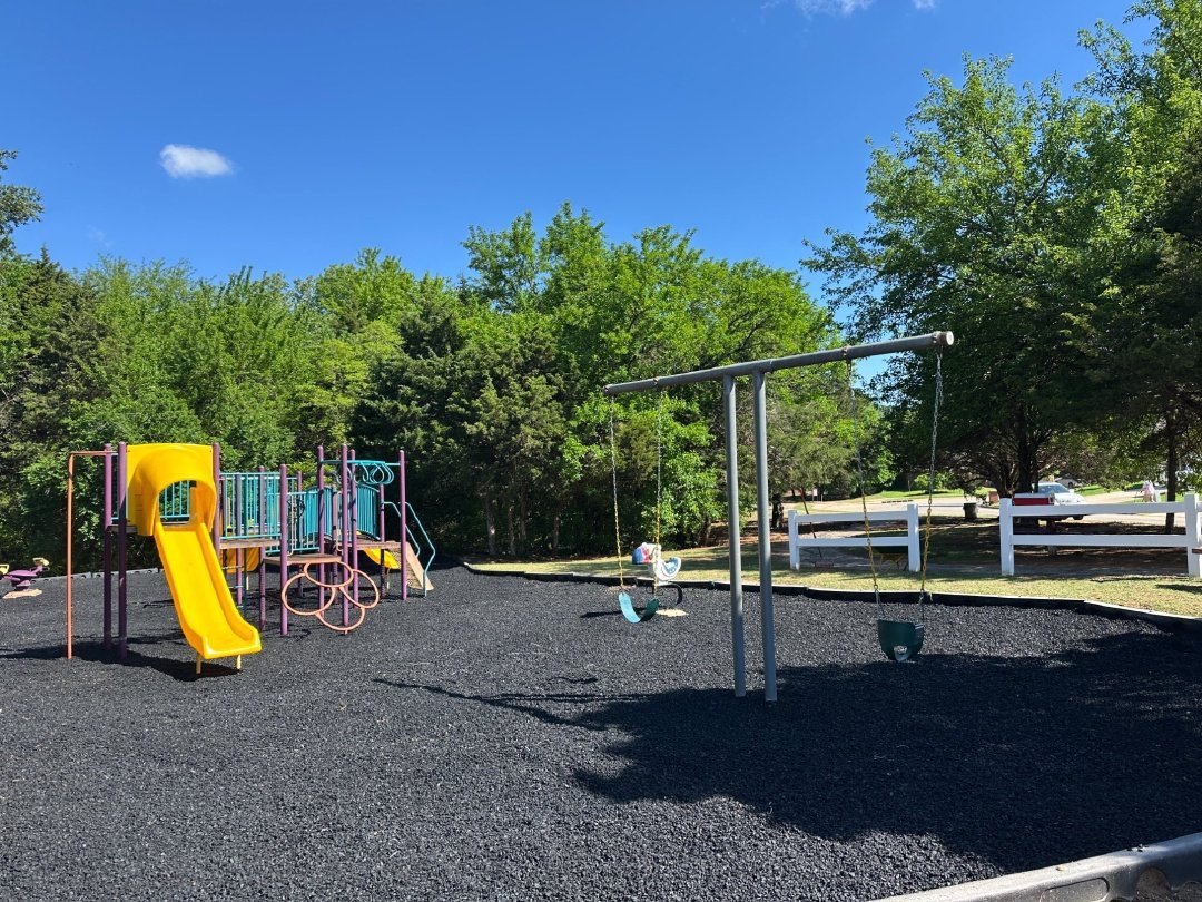 Commercial playground on black rubber mulch