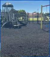 Taloga playground equipment on black rubber mulch